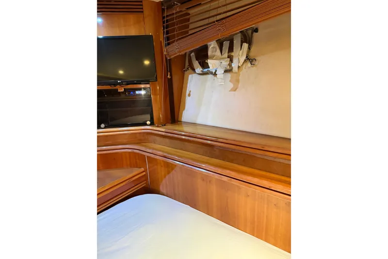 Slide: The Image of Interior of 2002 Sunseeker 105 Yacht with wooden cabinetry and mounted TV. - 44