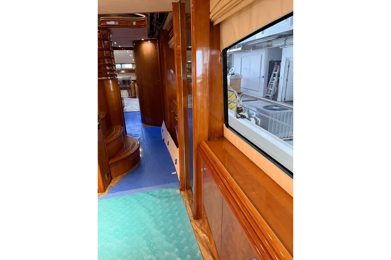 Slide: The Image of Interior view of 2002 Sunseeker 105 Yacht with polished wood finishes and large window. - 47