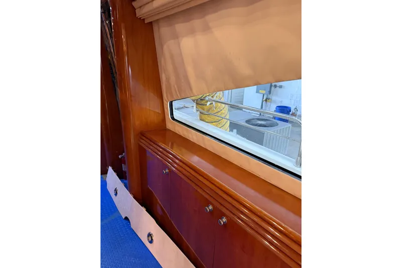 Slide: The Image of Interior view of 2002 Sunseeker 105 Yacht with wooden cabinetry and window. - 48