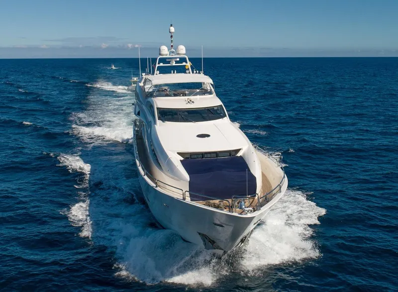 Slide: The Image of Sunseeker 105 Yacht 2002 cruising on open sea under clear blue sky. - 6
