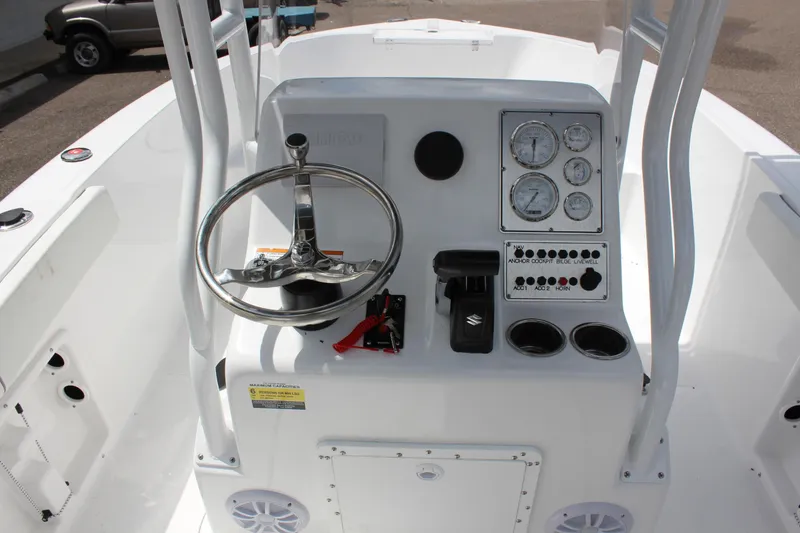 Slide: The Image of 2024 Clearwater 2000 CC boat console with steering wheel and gauges. - 13