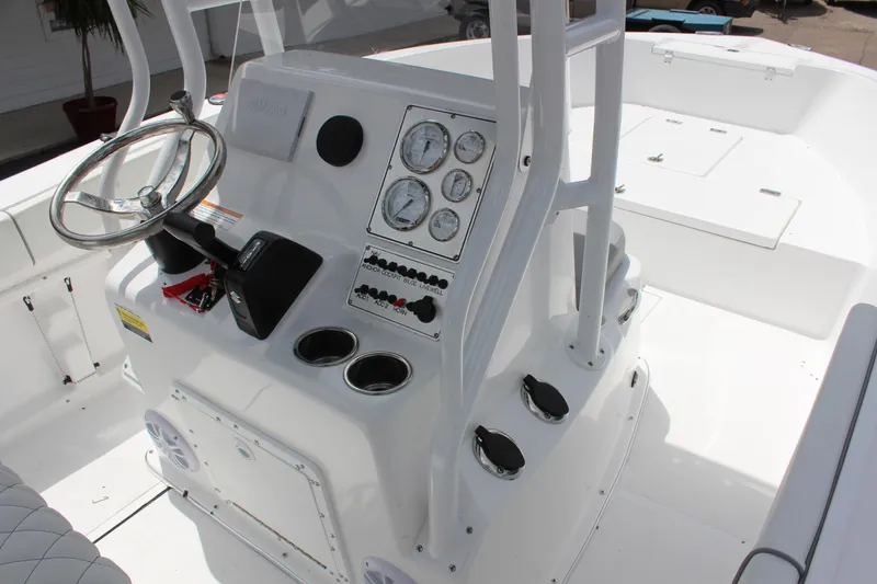 Slide: The Image of 2024 Clearwater 2000 CC boat console with steering wheel and gauges. - 14