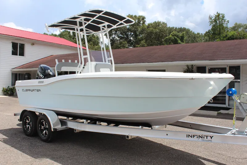 Slide: The Image of 2024 Clearwater 2000 CC boat on Infinity trailer outside building. - 3