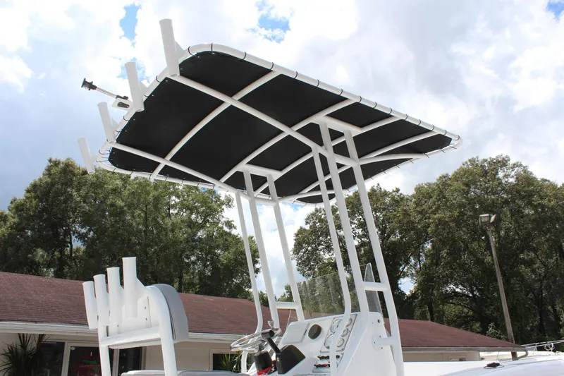 Slide: The Image of 2024 Clearwater 2000 CC boat with T-top and rod holders. - 5