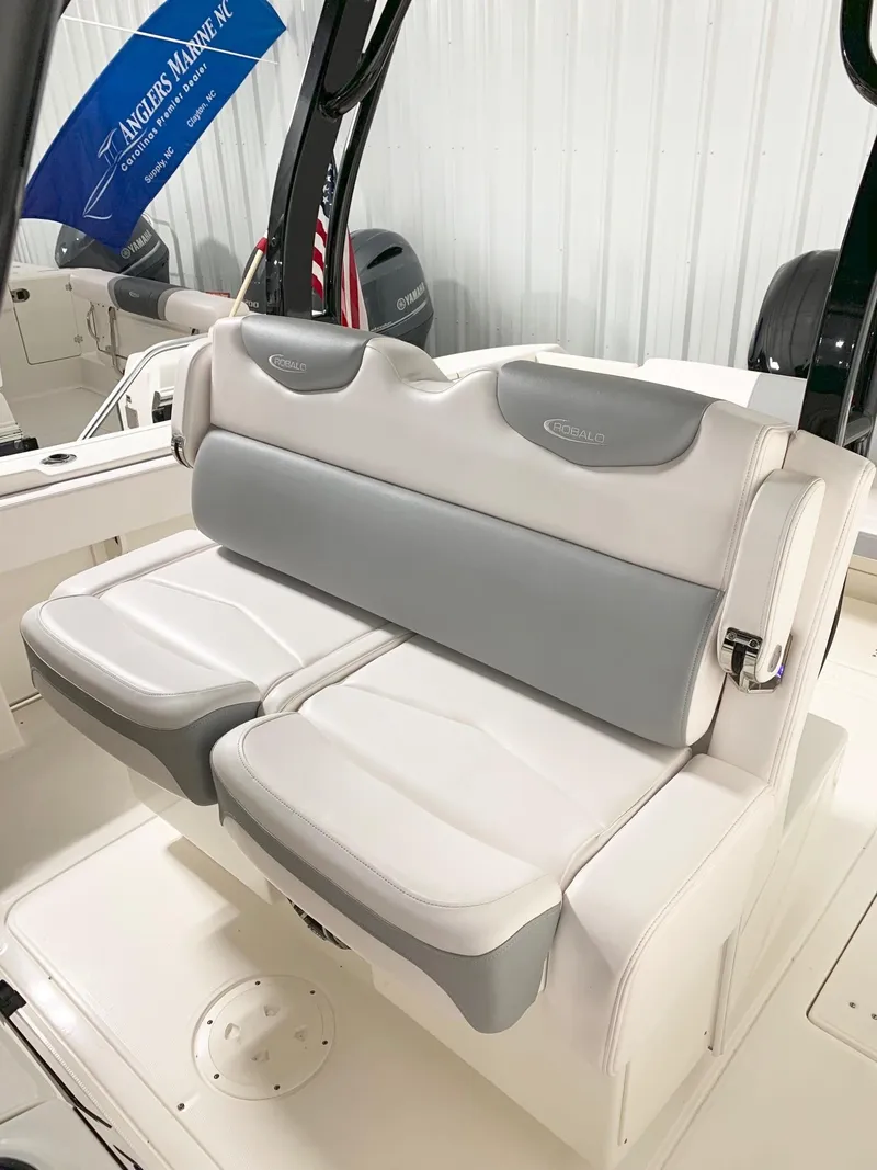 Slide: The Image of 2024 Robalo 302 boat with comfortable seating in white and gray upholstery. - 11