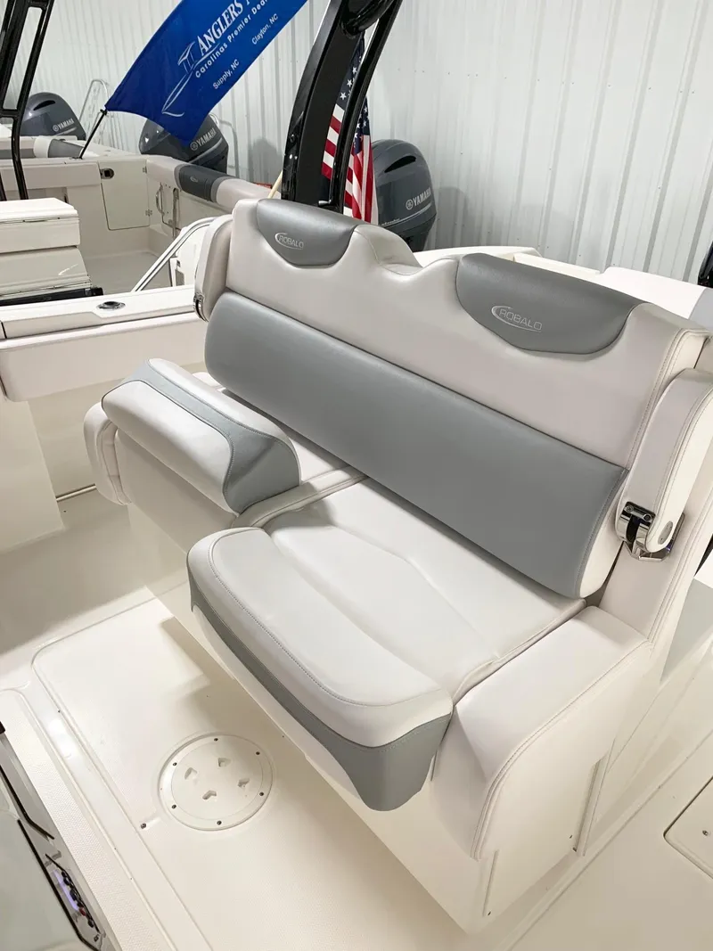 Slide: The Image of 2024 Robalo 302 boat interior seating with gray and white upholstery. - 12