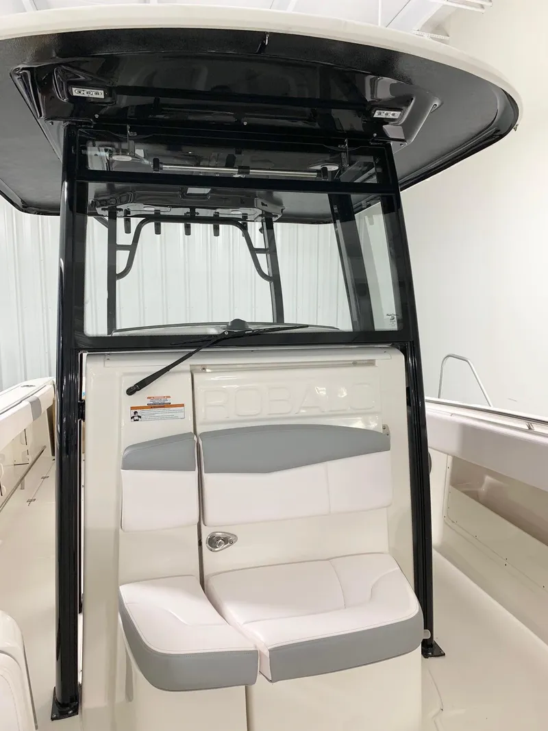 Slide: The Image of 2024 Robalo 302 boat interior with seating and console. - 13