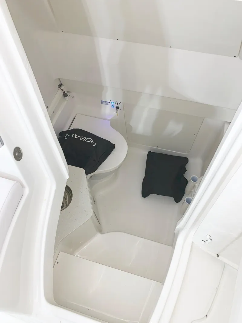 Slide: The Image of 2024 Robalo 302 boat interior with toilet and storage space. - 15