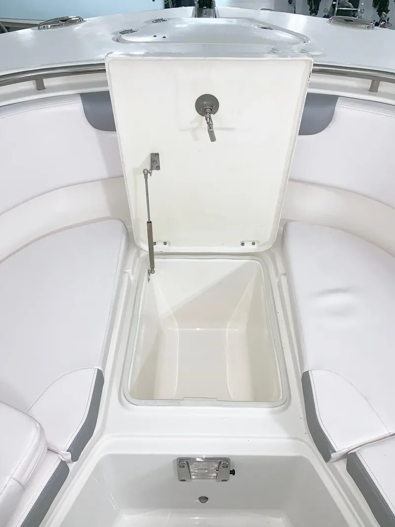 Slide: The Image of 2024 Robalo 302 boat storage compartment with open lid. - 19