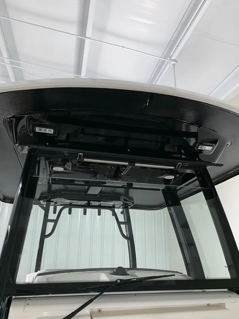 Slide: The Image of 2024 Robalo 302 boat windshield and hardtop in a showroom. - 8