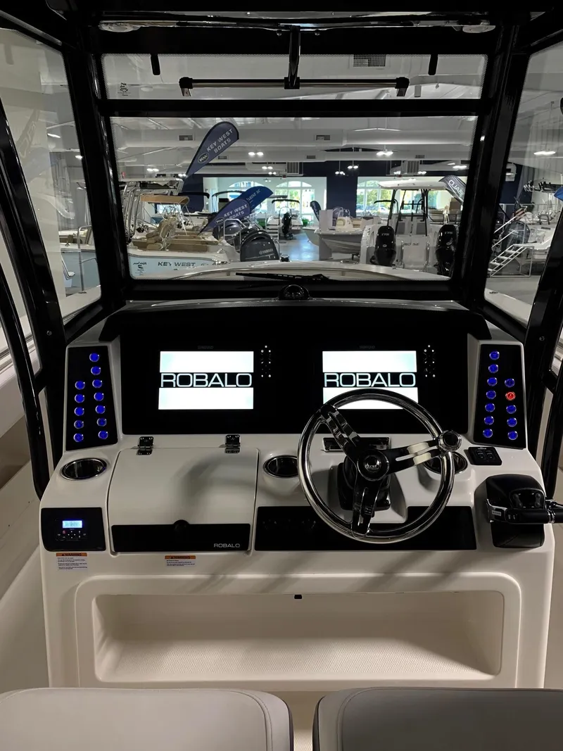 Slide: The Image of 2024 Robalo 302 boat dashboard with dual displays and modern controls. - 9