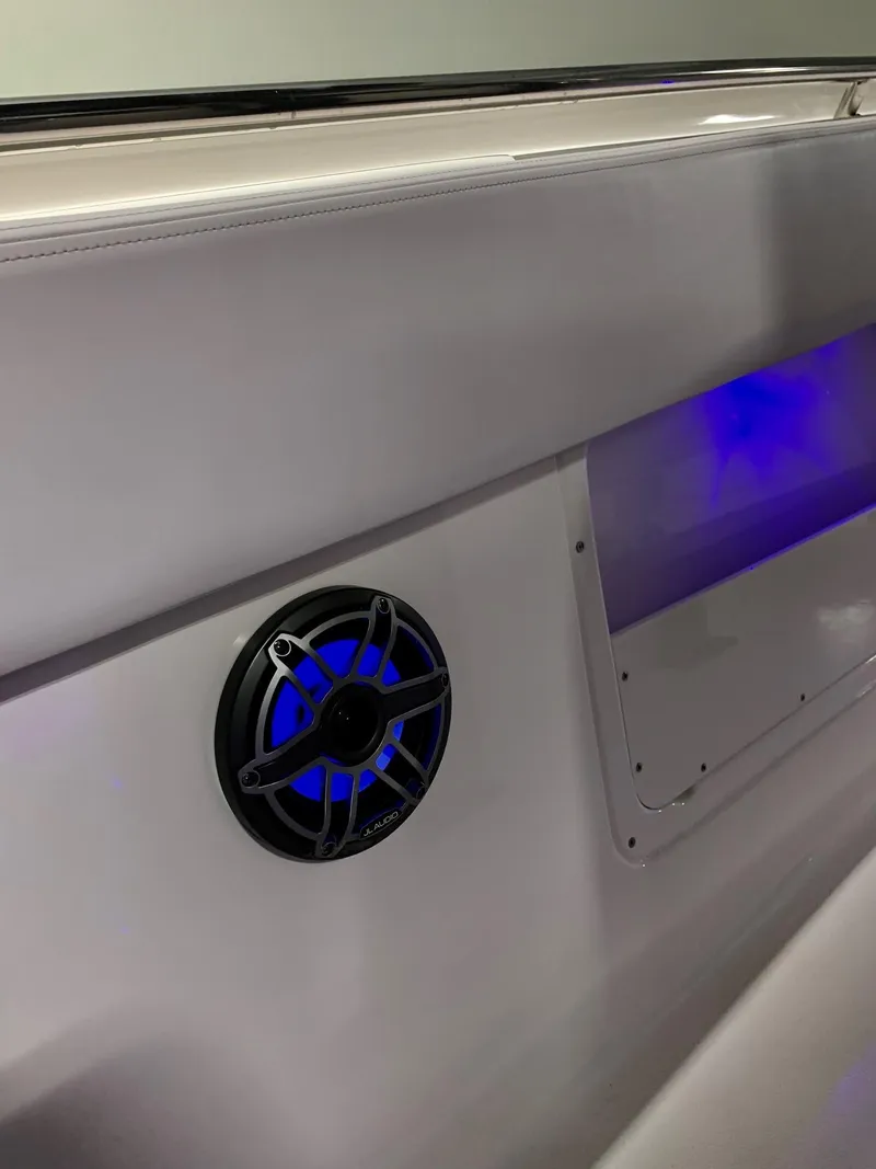 Slide: The Image of 2024 Robalo 302 boat interior with blue LED speaker lighting. - 10