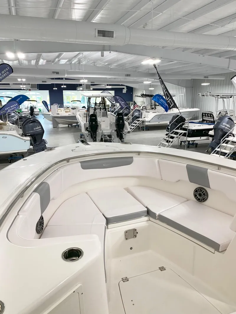 Slide: The Image of 2024 Robalo 302 boat interior on display in a showroom. - 14