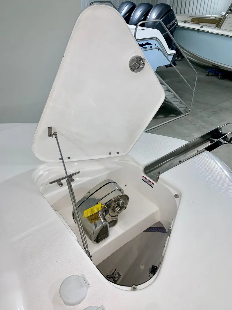 Slide: The Image of 2024 Robalo 302 boat anchor compartment with open hatch. - 18