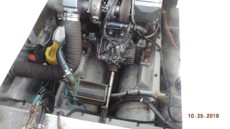 Slide: The Image of Engine compartment of a 1998 Mainship 30 PILOT boat, showing mechanical components. - 10