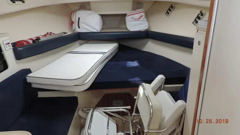 Slide: The Image of 1998 Mainship 30 PILOT cabin interior with seating and storage. - 11