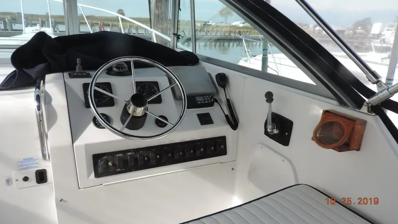 Slide: The Image of 1998 Mainship 30 PILOT boat helm with steering wheel and control panel. - 7