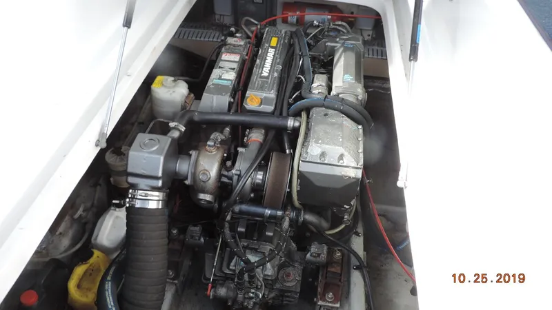 Slide: The Image of Engine compartment of a 1998 Mainship 30 PILOT boat, featuring a Yanmar diesel engine. - 9