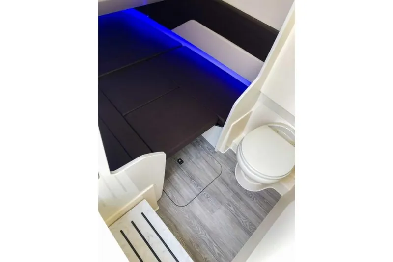 Slide: The Image of 2023 Scout 330 LXF cabin interior with bed, toilet, and modern lighting. - 10