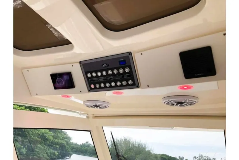 Slide: The Image of 2023 Scout 330 LXF boat interior control panel and speakers. - 12