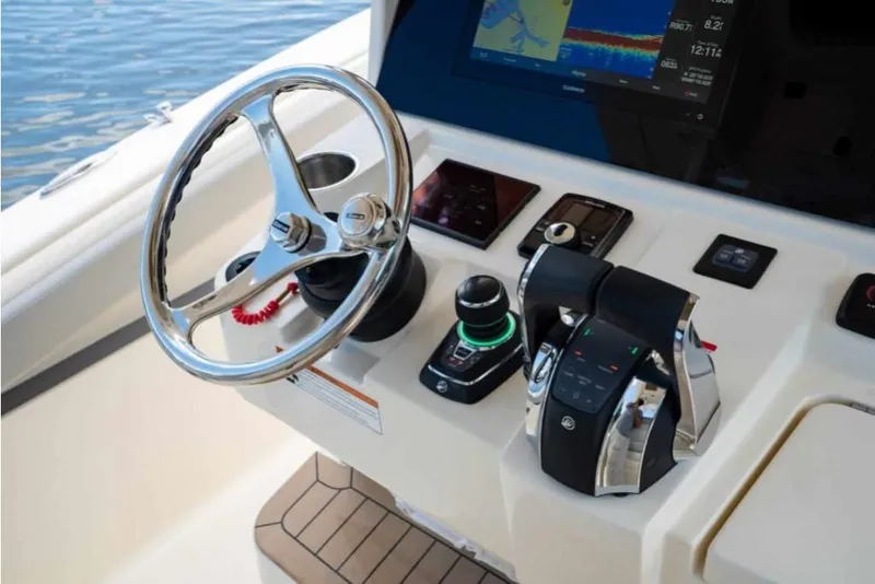 Slide: The Image of 2023 Scout 330 LXF boat helm with advanced controls and navigation display. - 22