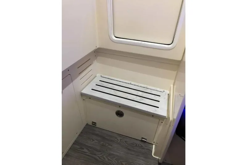 Slide: The Image of 2023 Scout 330 LXF interior bench seat with storage compartment. - 30