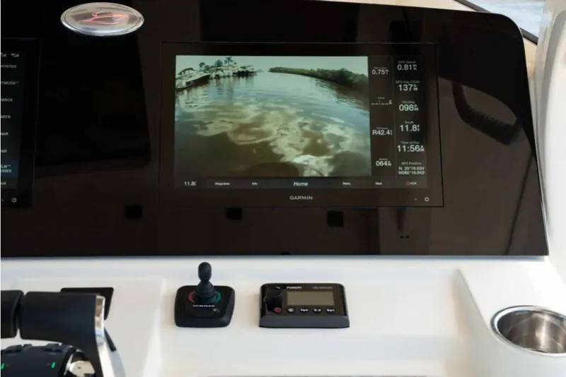 Slide: The Image of 2023 Scout 330 LXF boat dashboard with Garmin display and control panel. - 35