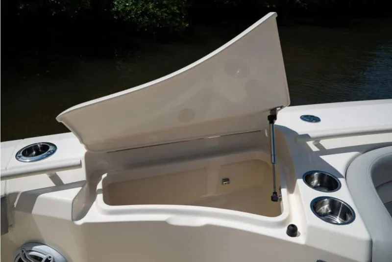 Slide: The Image of 2023 Scout 330 LXF boat storage compartment with open lid. - 37