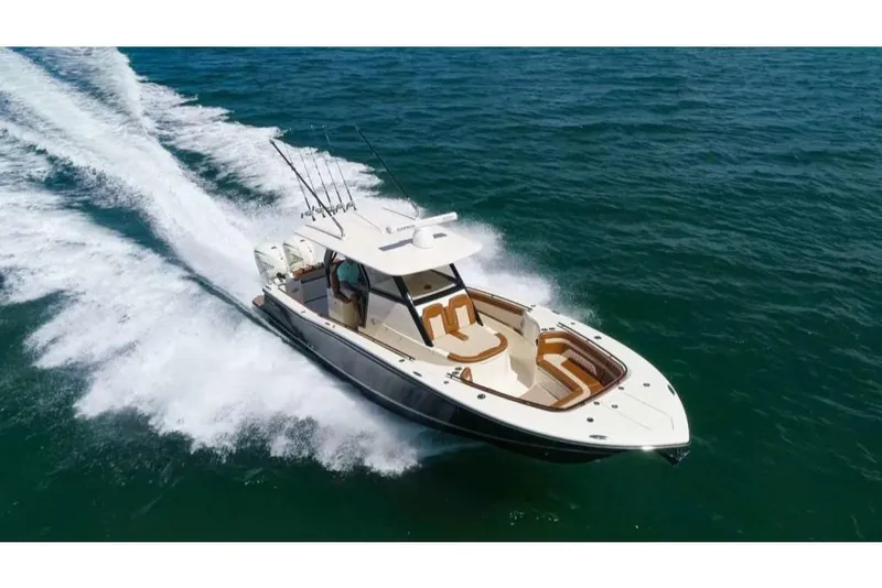 Slide: The Image of 2023 Scout 330 LXF boat cruising on open water. - 4