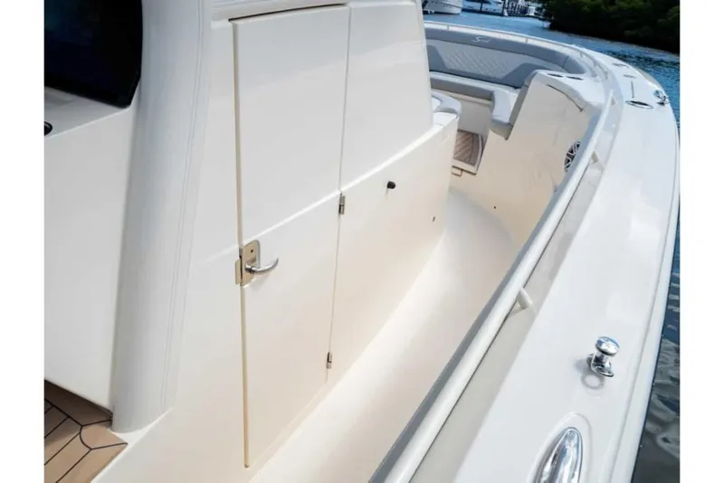 Slide: The Image of 2023 Scout 330 LXF boat deck with storage compartments. - 40