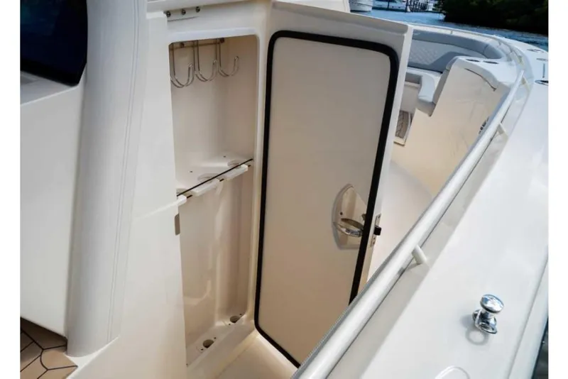 Slide: The Image of 2023 Scout 330 LXF boat storage compartment with open door. - 41