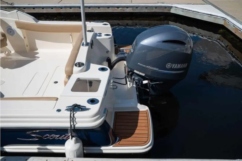 Slide: The Image of 2023 Scout 215 Dorado boat with Yamaha outboard motor docked. - 10