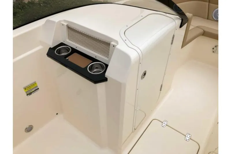 Slide: The Image of 2023 Scout 215 Dorado boat interior with cup holders and storage compartment. - 11
