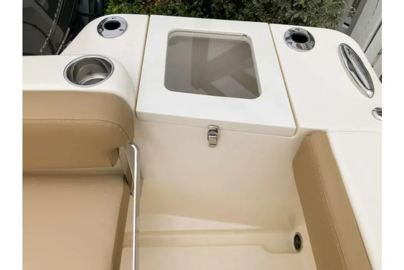 Slide: The Image of 2023 Scout 215 Dorado boat interior with beige seating and cup holders. - 12