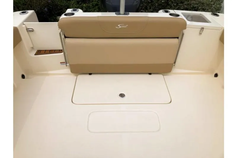 Slide: The Image of 2023 Scout 215 Dorado boat interior with beige seating and storage compartments. - 15