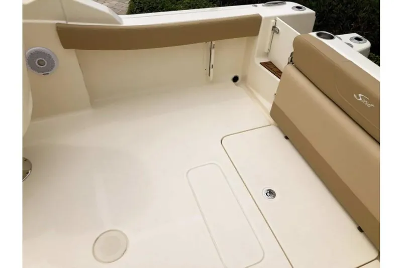 Slide: The Image of 2023 Scout 215 Dorado boat interior with beige seating and white deck. - 16