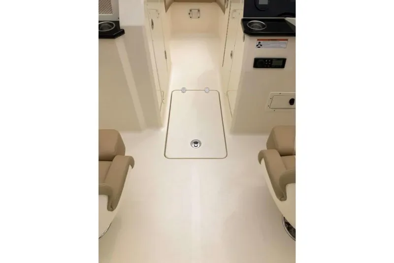 Slide: The Image of 2023 Scout 215 Dorado boat interior with beige seating and storage compartment. - 17