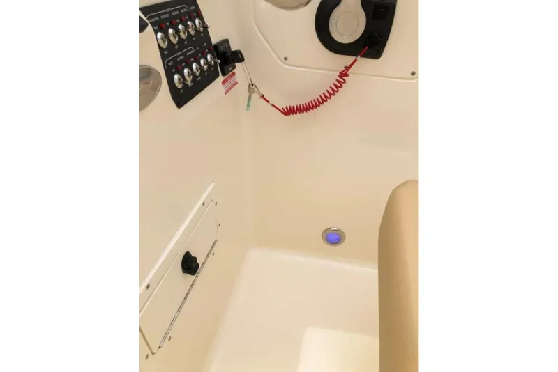 Slide: The Image of 2023 Scout 215 Dorado boat interior control panel and seating area. - 20