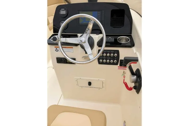 Slide: The Image of 2023 Scout 215 Dorado boat dashboard with steering wheel and control panel. - 24