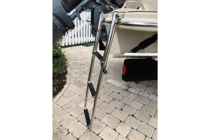 Slide: The Image of 2023 Scout 215 Dorado boat with a stainless steel swim ladder. - 25