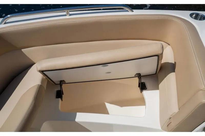 Slide: The Image of 2023 Scout 215 Dorado boat with open storage compartment under beige seating. - 27