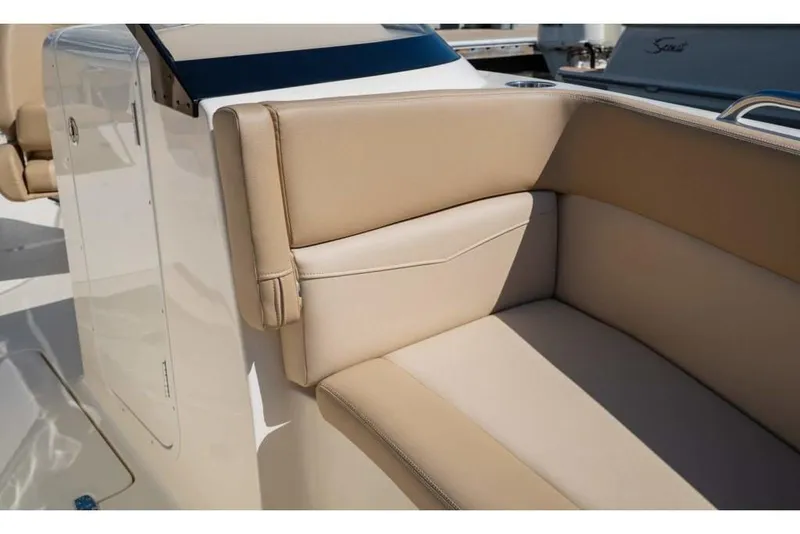 Slide: The Image of 2023 Scout 215 Dorado boat interior with beige cushioned seating. - 29