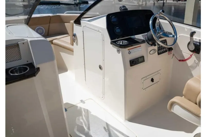 Slide: The Image of 2023 Scout 215 Dorado boat interior with steering console and seating. - 31