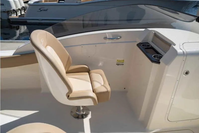Slide: The Image of 2023 Scout 215 Dorado boat interior with beige captain's chair and console. - 34
