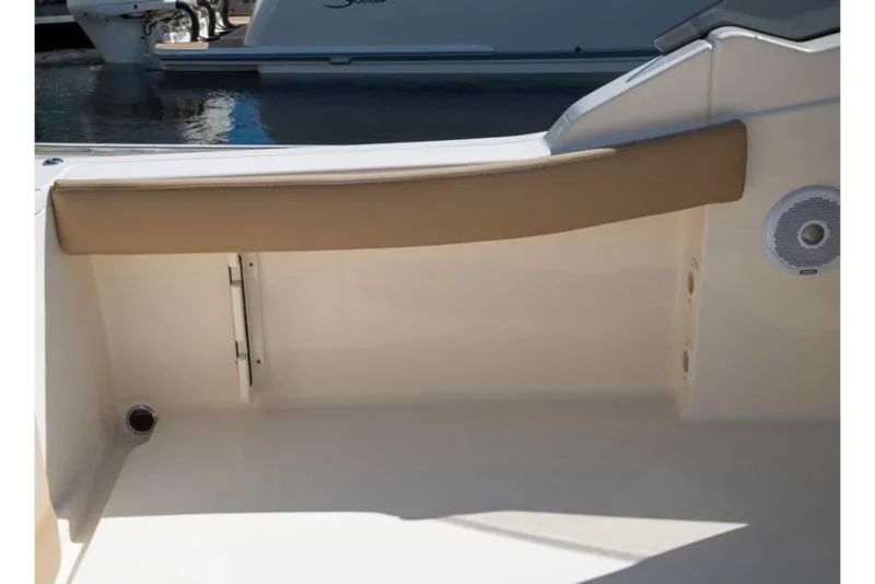 Slide: The Image of 2023 Scout 215 Dorado boat interior with beige seating and speaker. - 36
