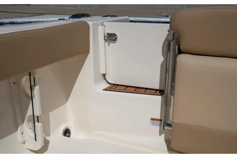 Slide: The Image of 2023 Scout 215 Dorado boat interior with beige seating and storage compartment. - 37