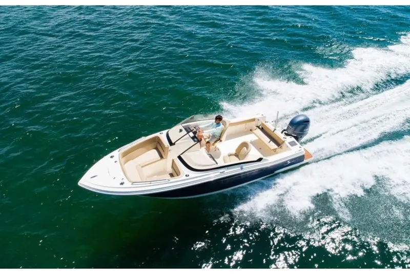 Slide: The Image of 2023 Scout 215 Dorado boat cruising on open water. - 4