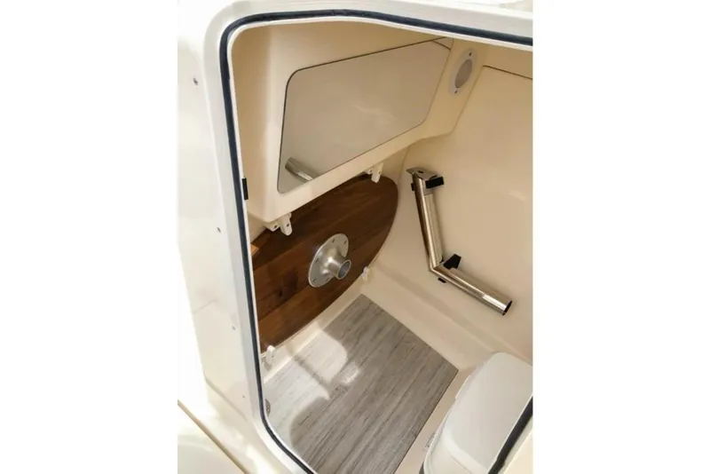 Slide: The Image of 2023 Scout 215 Dorado boat interior cabin with wooden accents and modern fixtures. - 40
