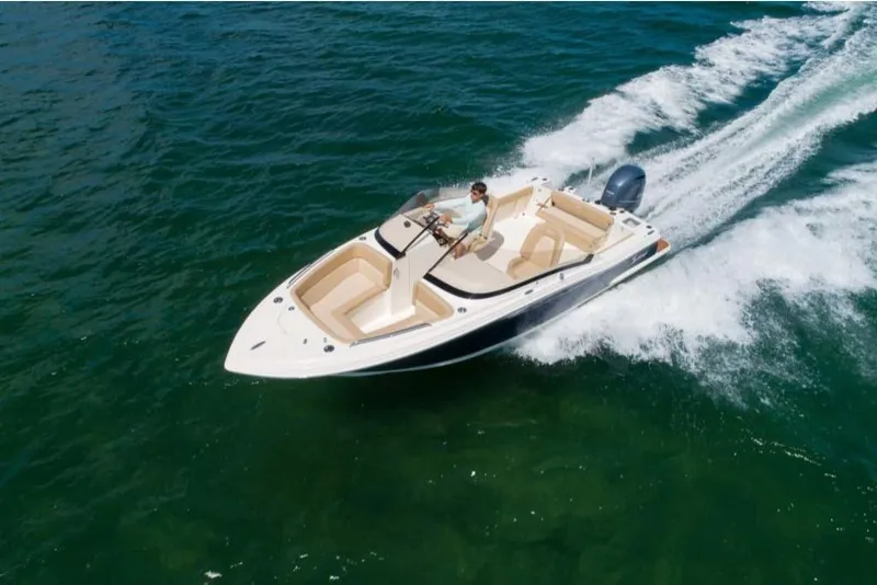 Slide: The Image of 2023 Scout 215 Dorado boat cruising on open water. - 6