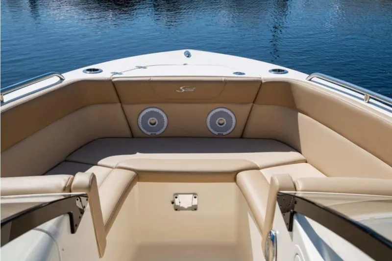 Slide: The Image of 2023 Scout 215 Dorado boat interior with beige seating and speakers. - 7